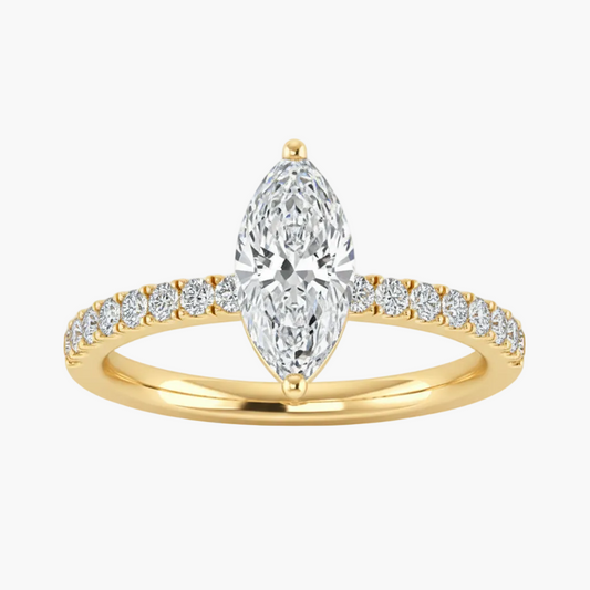 Gold ring with a pear-shaped diamond and smaller diamonds on a white background