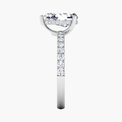 Diamond ring with a large center stone and smaller stones on the band against a white background