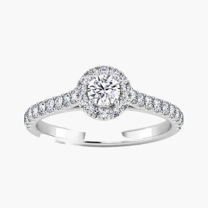 Diamond ring with a halo and side stones on a white background