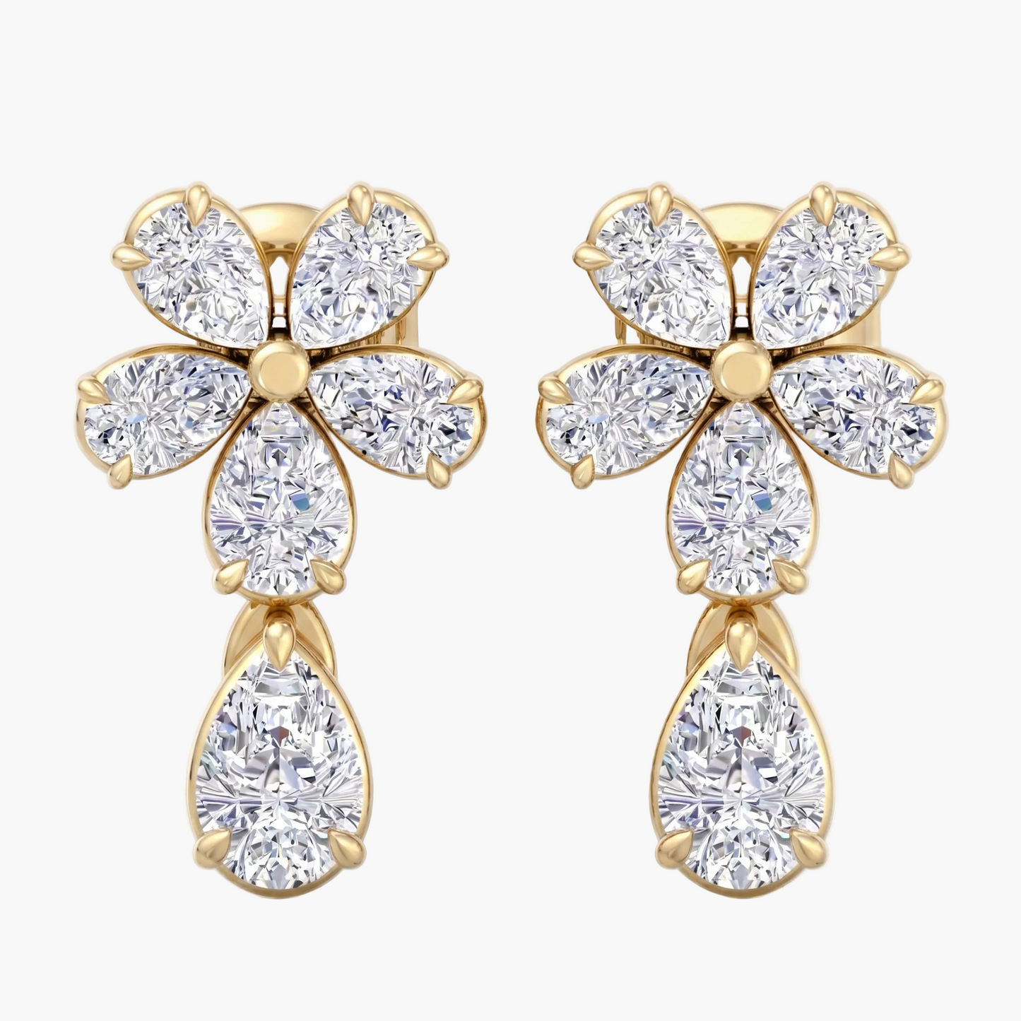 Gold earrings with diamond-like stones on a white background