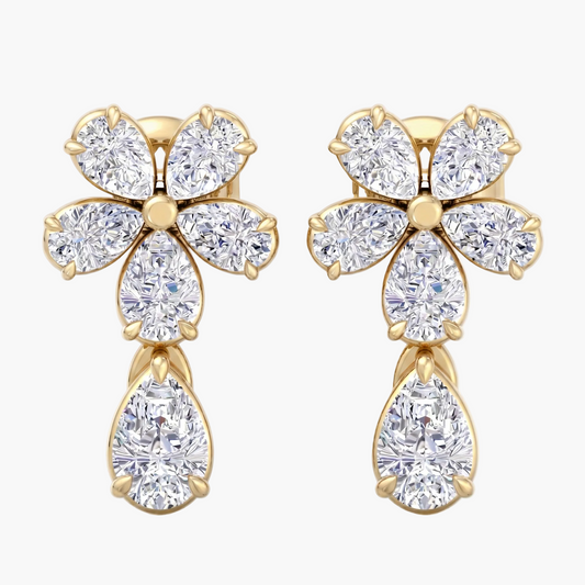 Gold earrings with diamond-like stones on a white background