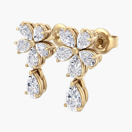 Gold earring with diamond-like stones on a white background