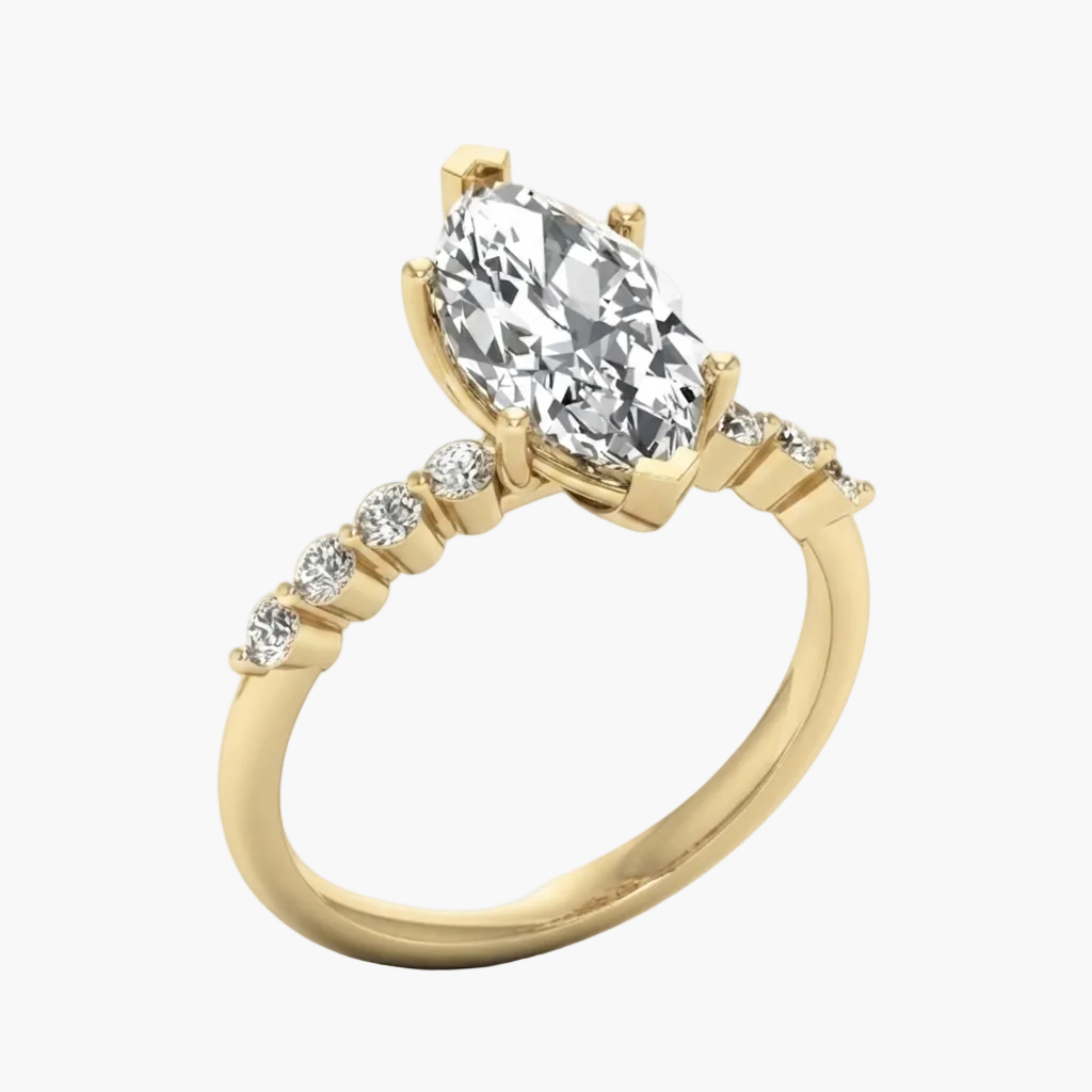 A yellow gold engagement ring featuring a large pear-cut center stone and a pavé band with smaller round stones, shown on a light gray background.
