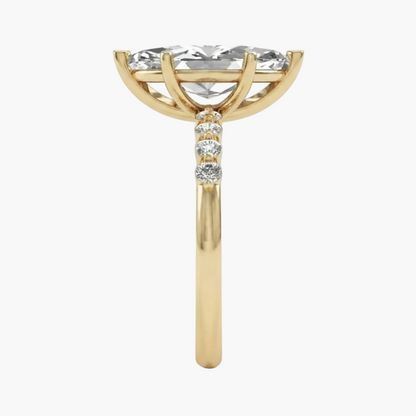 A yellow gold ring featuring a large round brilliant-cut clear gemstone in a prong setting, with three smaller round diamonds along the shank, shown on a plain white background.