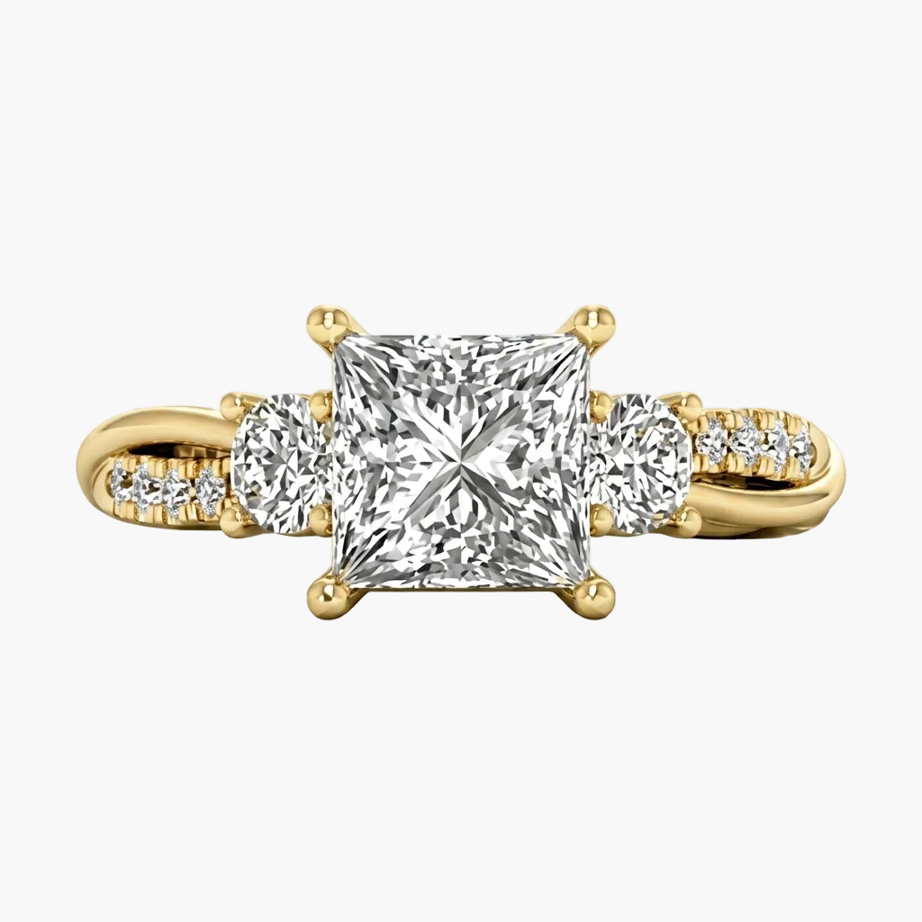 Gold ring with a large diamond and smaller diamonds on the sides against a white background
