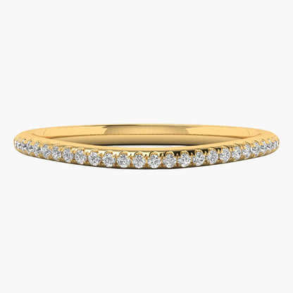 Gold ring with small diamonds on a white background