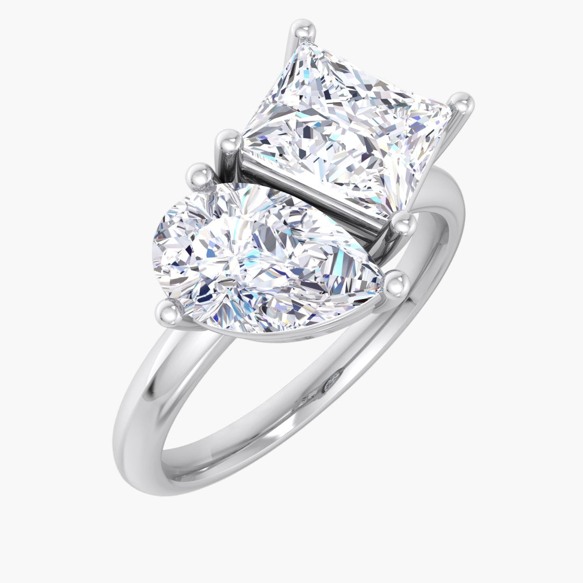 Diamond ring with heart-shaped and princess-cut diamonds on a white background