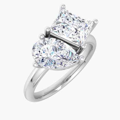 Diamond ring with heart-shaped and princess-cut diamonds on a white background