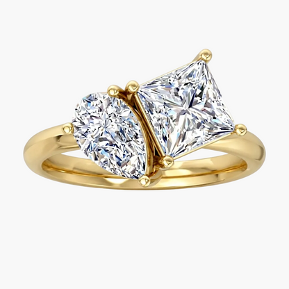 Gold ring with two diamonds on a white background