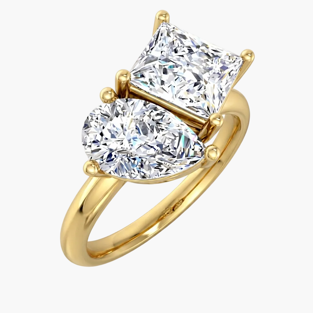Gold ring with two diamond stones on a white background
