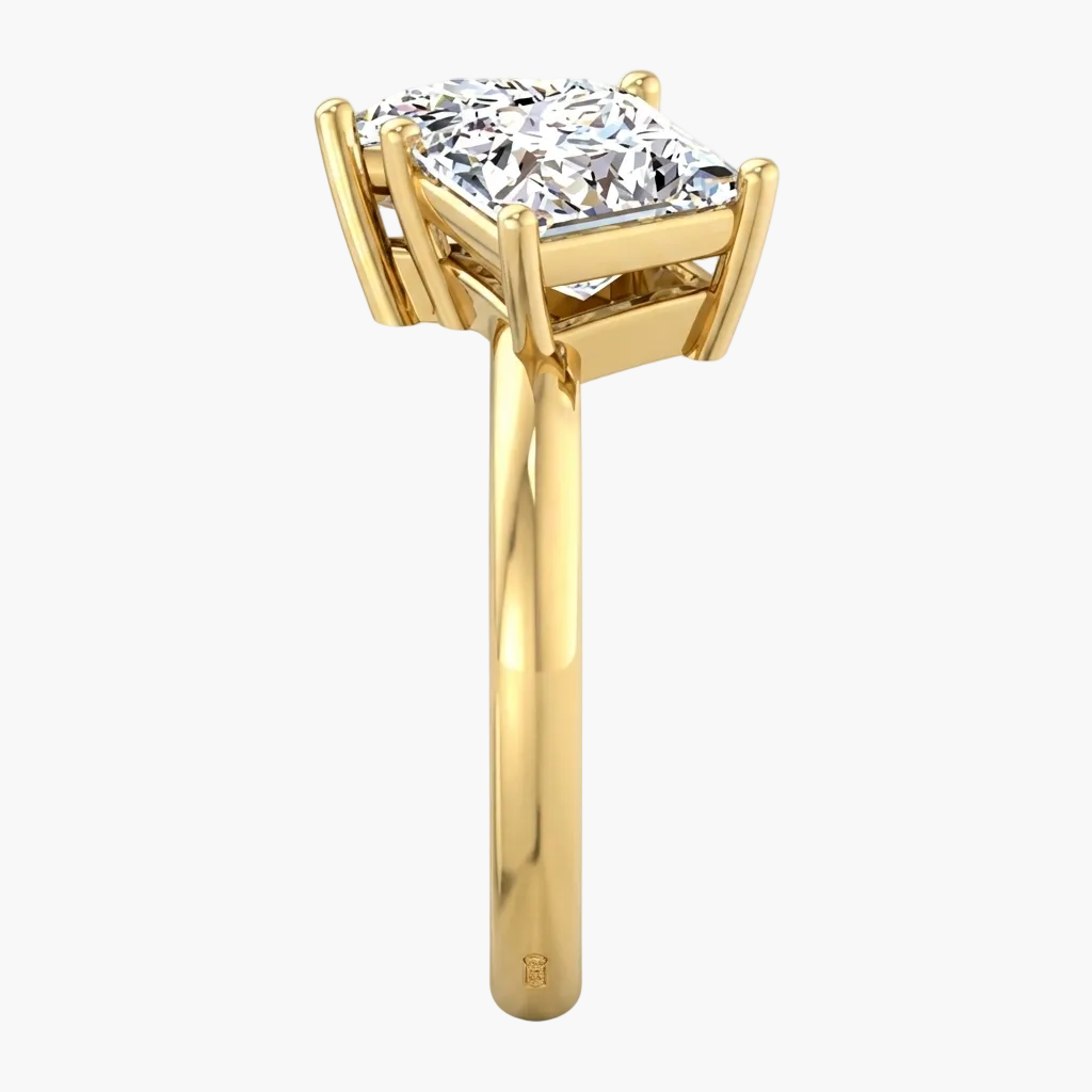 Gold ring with a large diamond on a white background