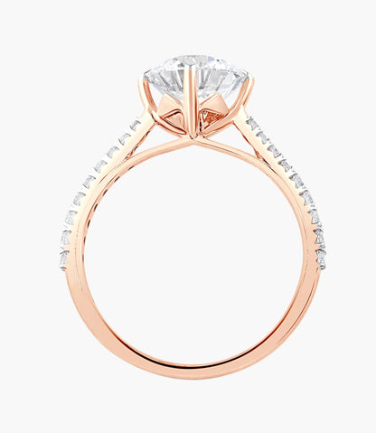 Rose gold ring with a large diamond and smaller diamonds on the band against a white background