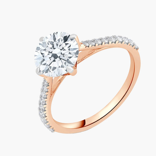 Rose gold ring with a large diamond and smaller diamonds on the band against a white background