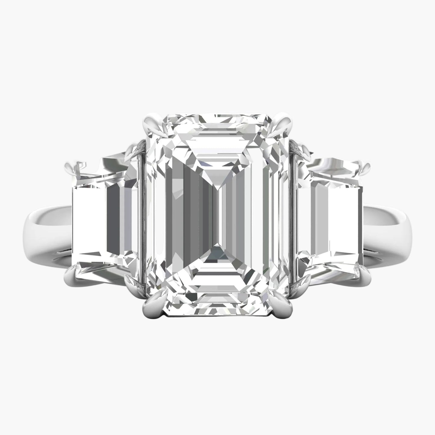 Diamond ring with emerald-cut center stone on a white background