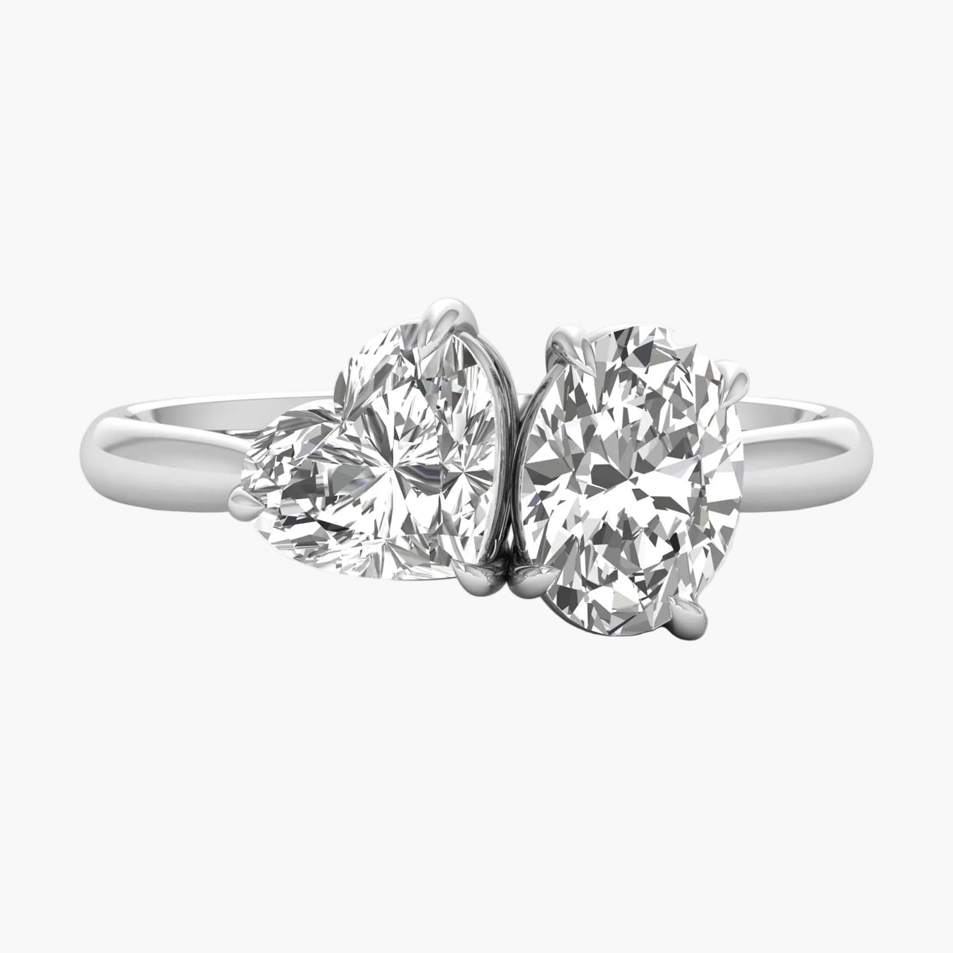 Diamond ring with two heart-shaped gemstones on a white background