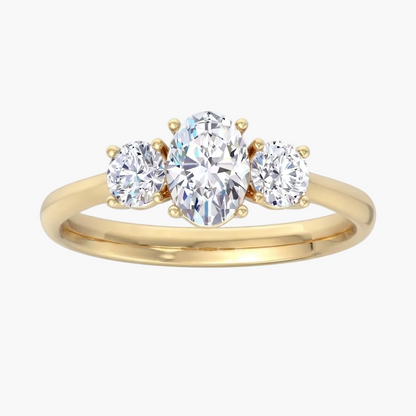 Gold ring with three clear gemstones on a white background