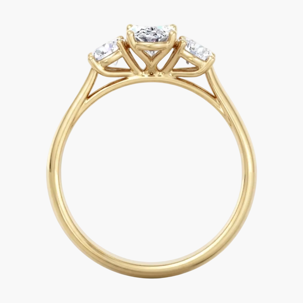 Gold ring with three diamonds on a white background