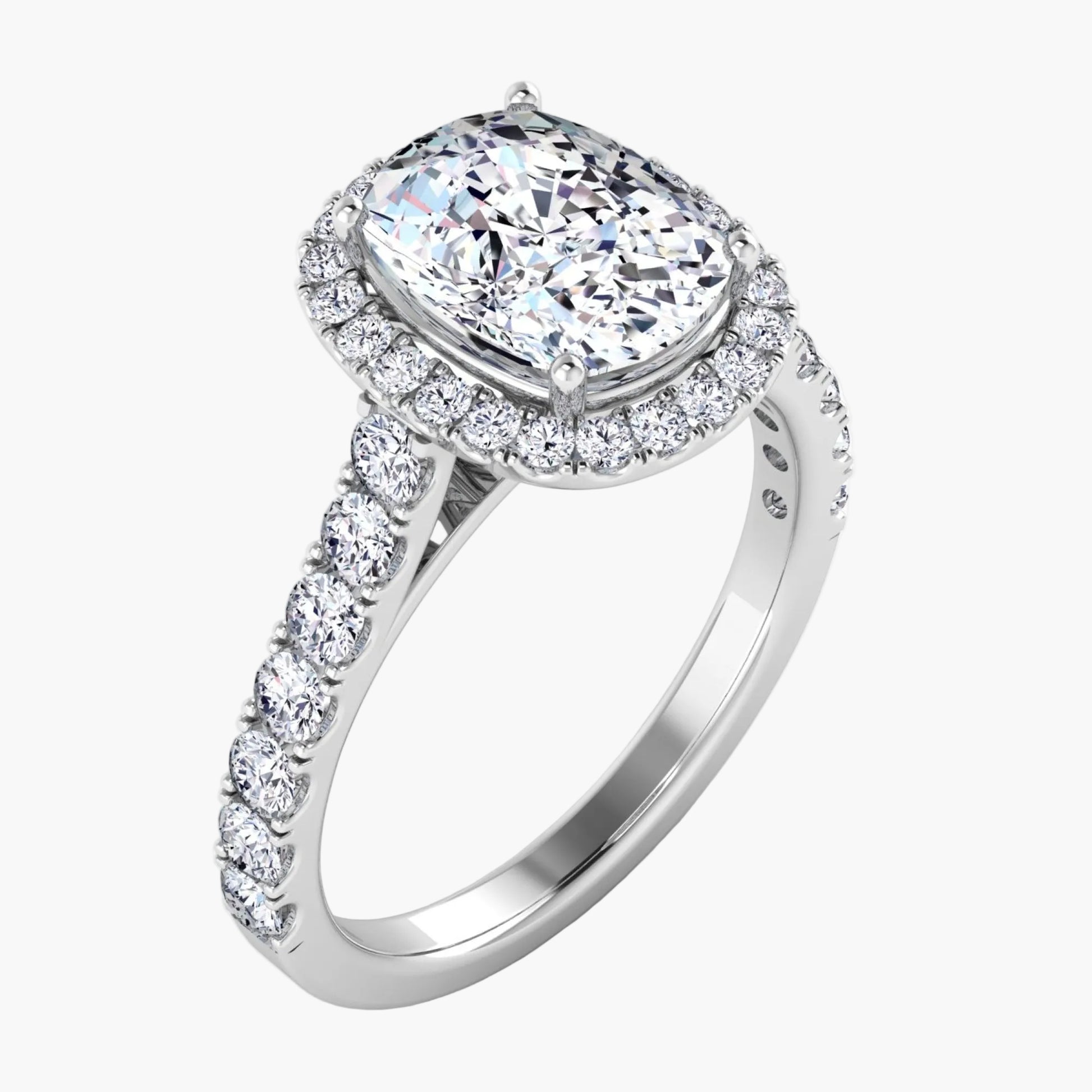 Diamond ring with a halo and side stones on a white background