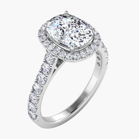 Diamond ring with a halo and side stones on a white background