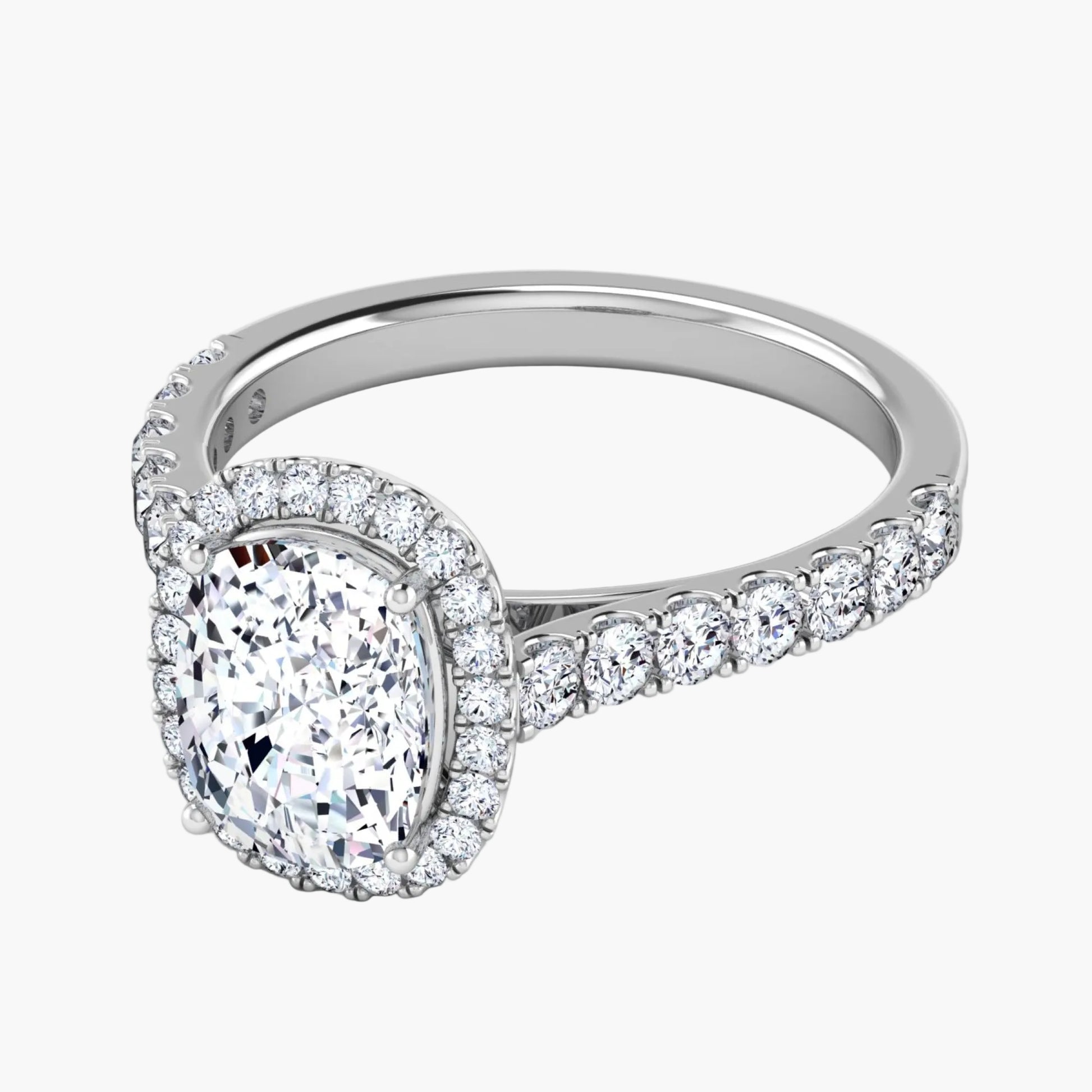 Diamond ring with a pear-shaped center stone on a white background