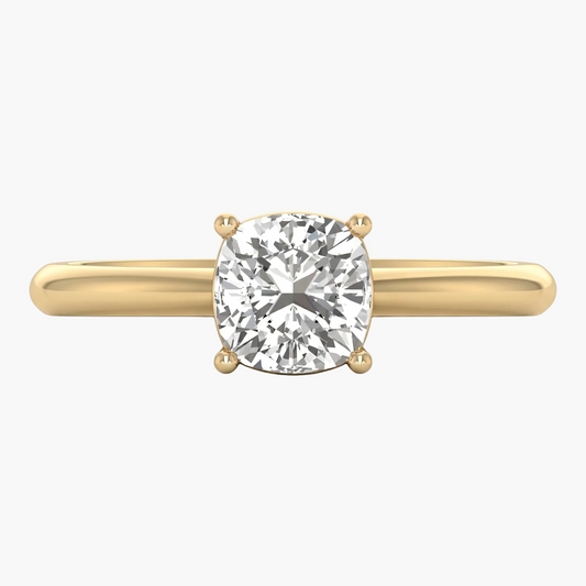 Gold ring with a large diamond on a white background