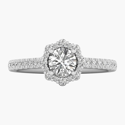 Diamond ring with a halo and side stones on a white background