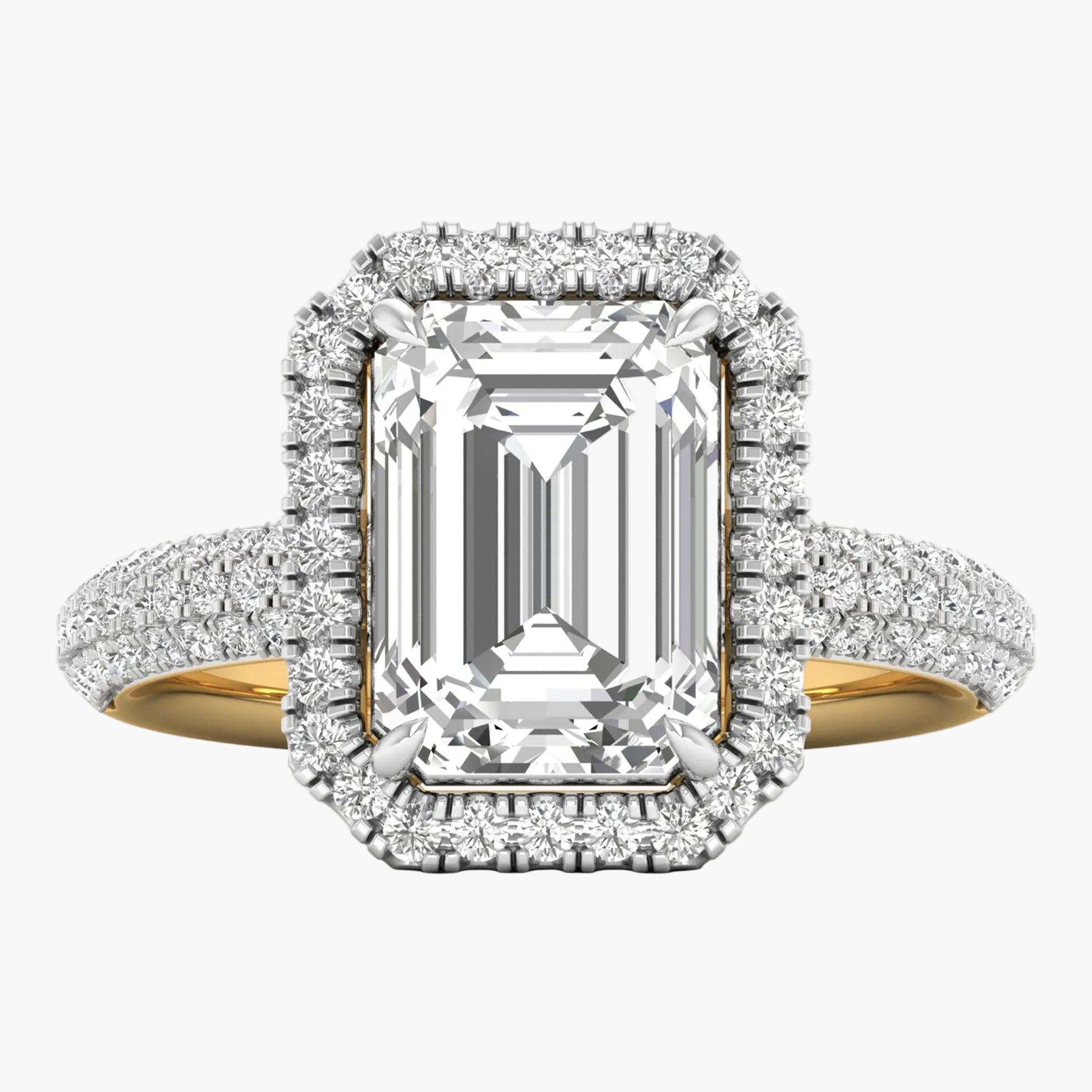 Diamond ring with emerald-cut center stone and halo on a white background