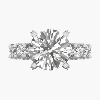 Diamond ring with a central gemstone and two smaller stones on a white background