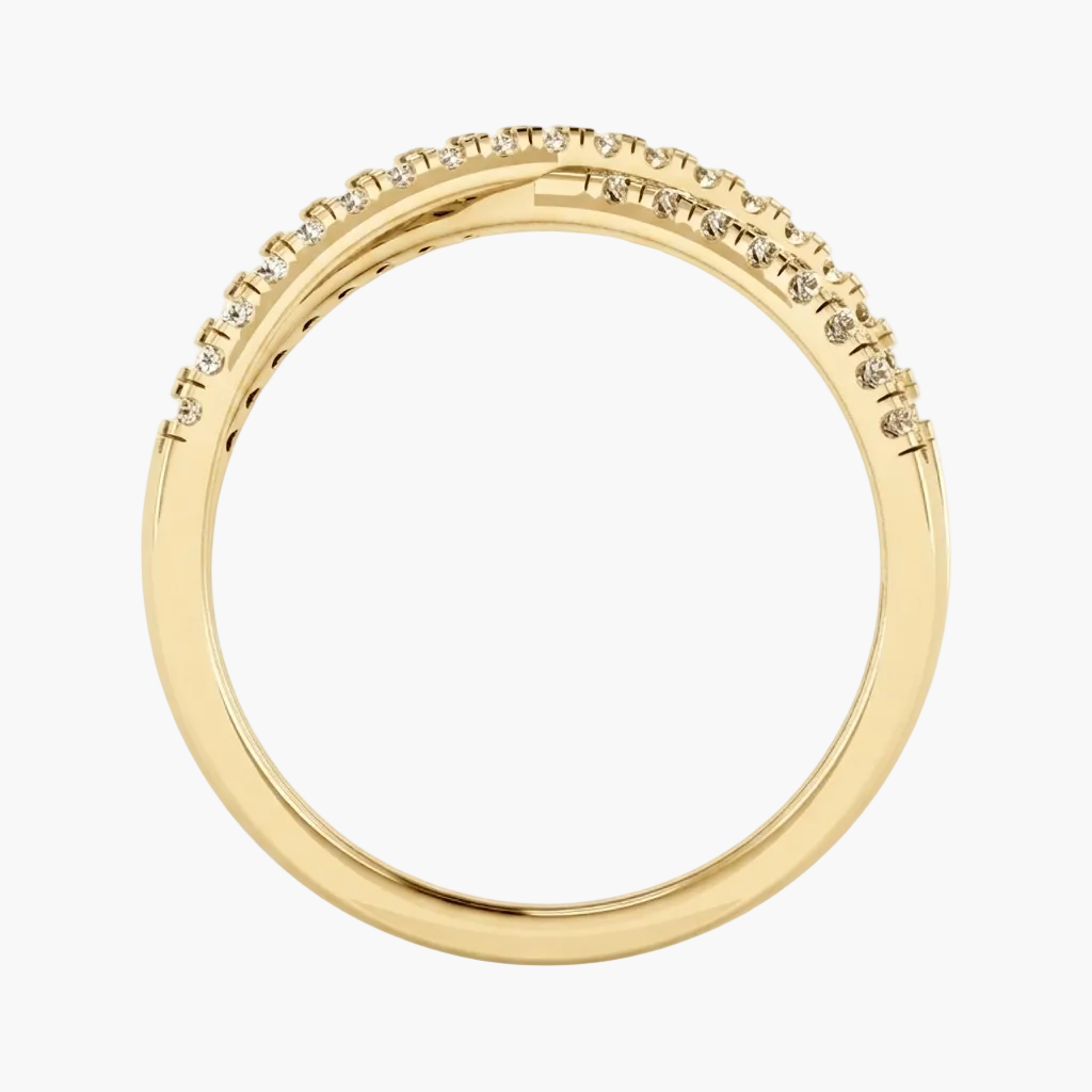 A yellow gold band ring featuring a single row of small clear pavé-set stones along the upper outer curve, shown on a plain white background.