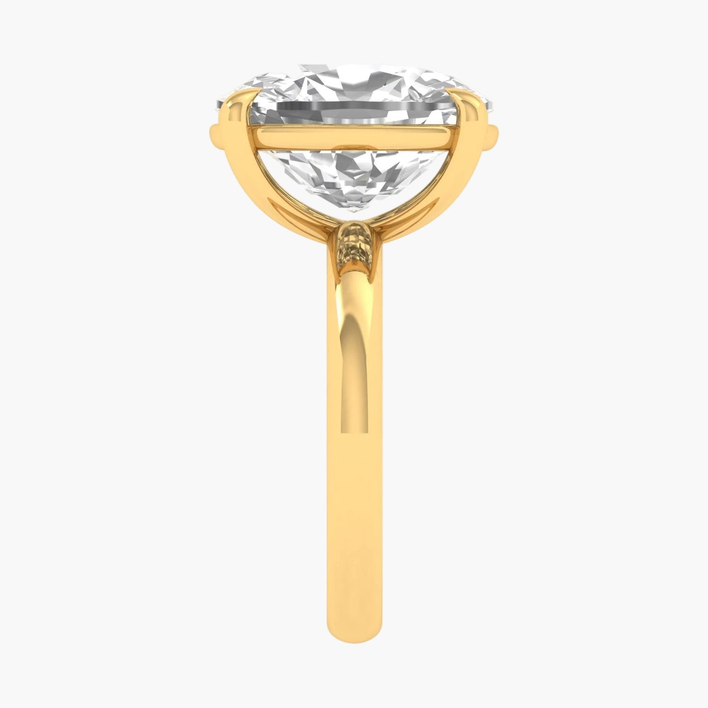 Gold ring with a large clear gemstone on a white background