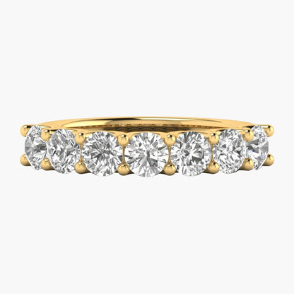 Gold ring with round diamonds on a white background
