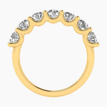 Gold ring with clear gemstones on a white background