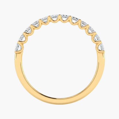 Gold ring with diamond accents on a white background
