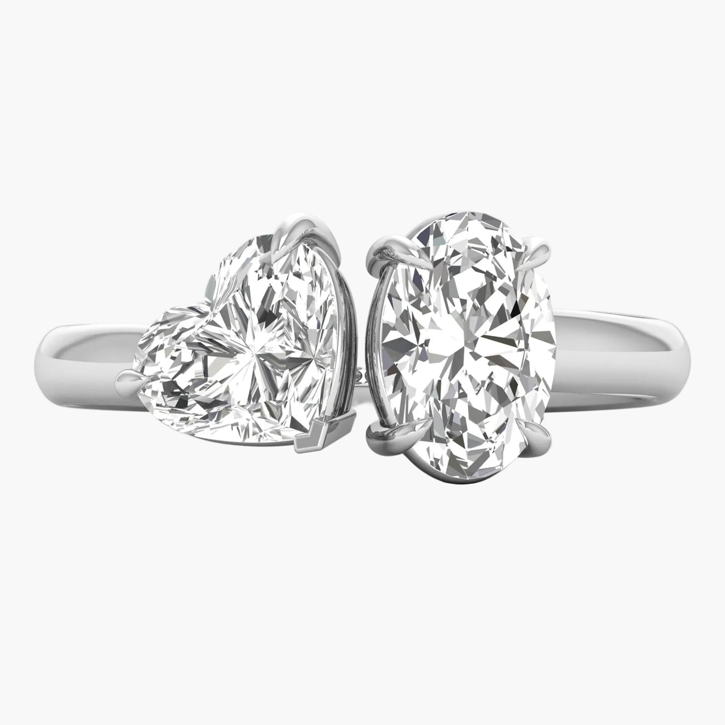 Two diamond rings with heart and round designs on a white background