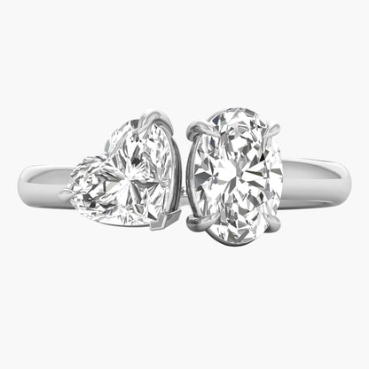 Two diamond rings with heart and round designs on a white background