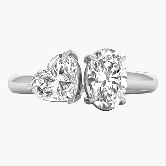 Two diamond rings with heart and round designs on a white background