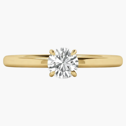A classic solitaire engagement ring featuring a round brilliant-cut diamond set in a yellow gold four-prong setting on a polished gold band, shown against a clean white background.