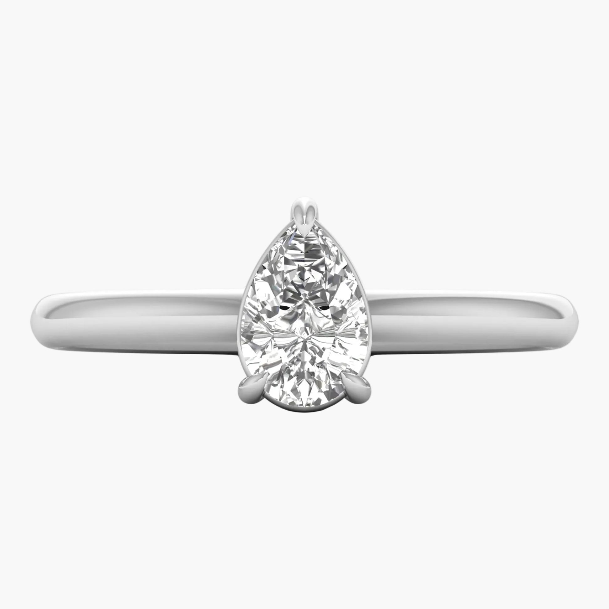 Diamond ring with pear-shaped gemstone on a white background
