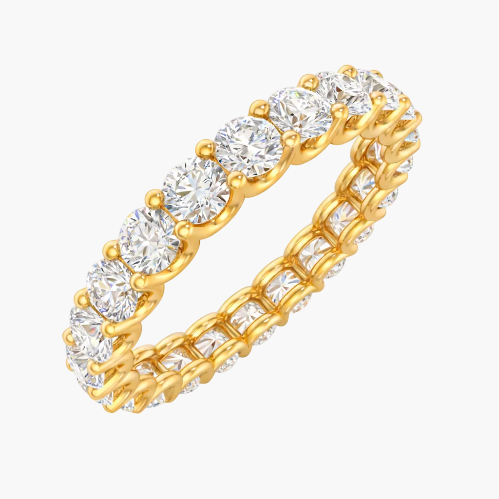 Gold ring with clear gemstones on a white background