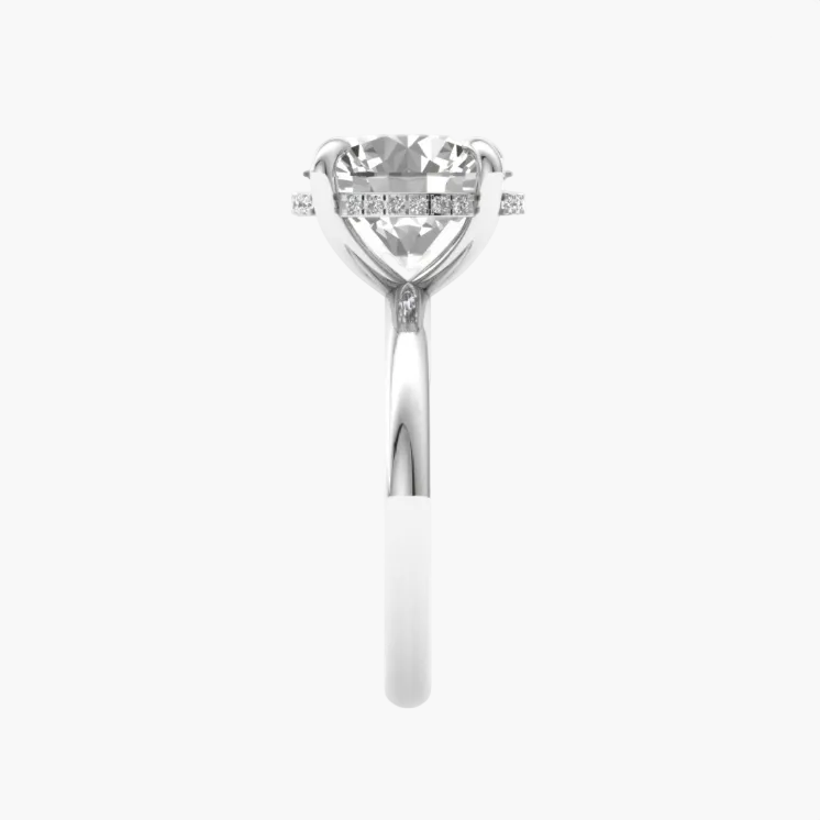 Silver ring with a large central diamond and smaller diamonds on the band against a white background