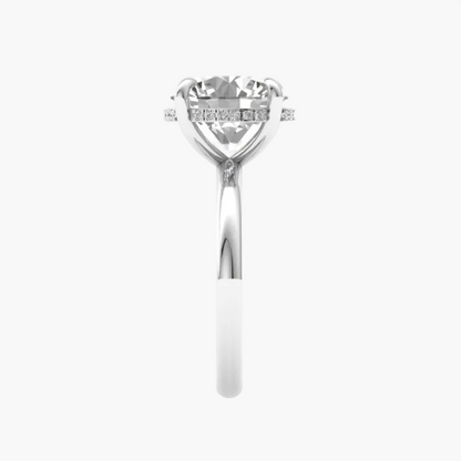 Silver ring with a large central diamond and smaller diamonds on the band against a white background
