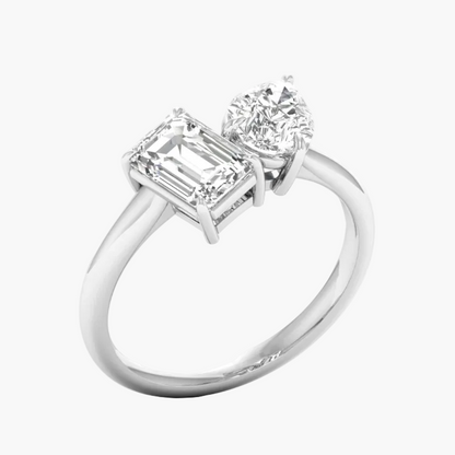 Diamond ring with emerald-cut and round diamonds on a white background