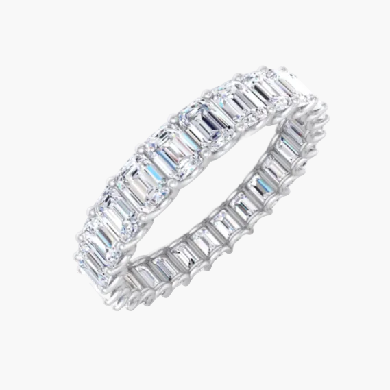Diamond ring with emerald-cut stones on a white background