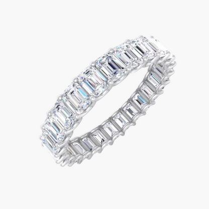 Diamond ring with emerald-cut stones on a white background