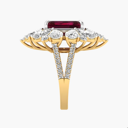 Gold ring with a red gemstone and diamond-studded band on a white background