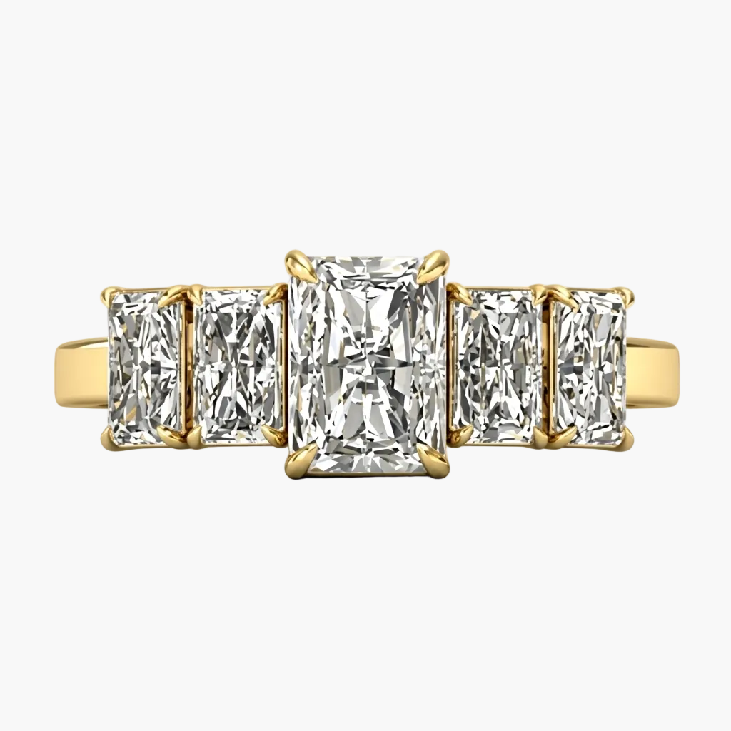 Gold ring with three rectangular diamonds on a light gray background