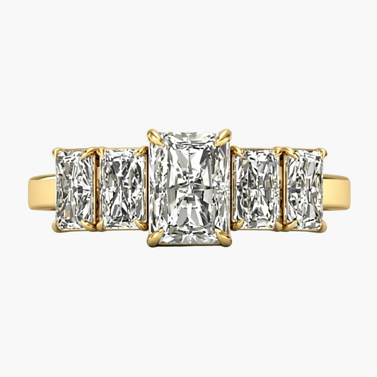Gold ring with three rectangular diamonds on a light gray background