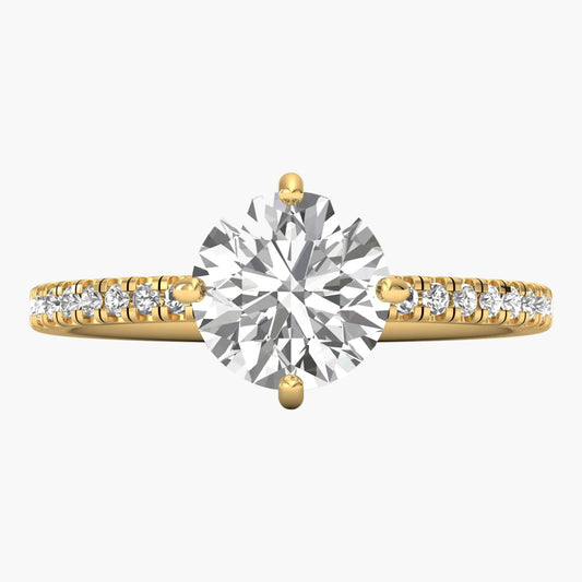 Gold ring with a large diamond and smaller diamonds on the band against a white background