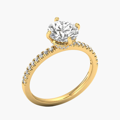Gold ring with a large diamond and smaller diamonds on the band against a white background