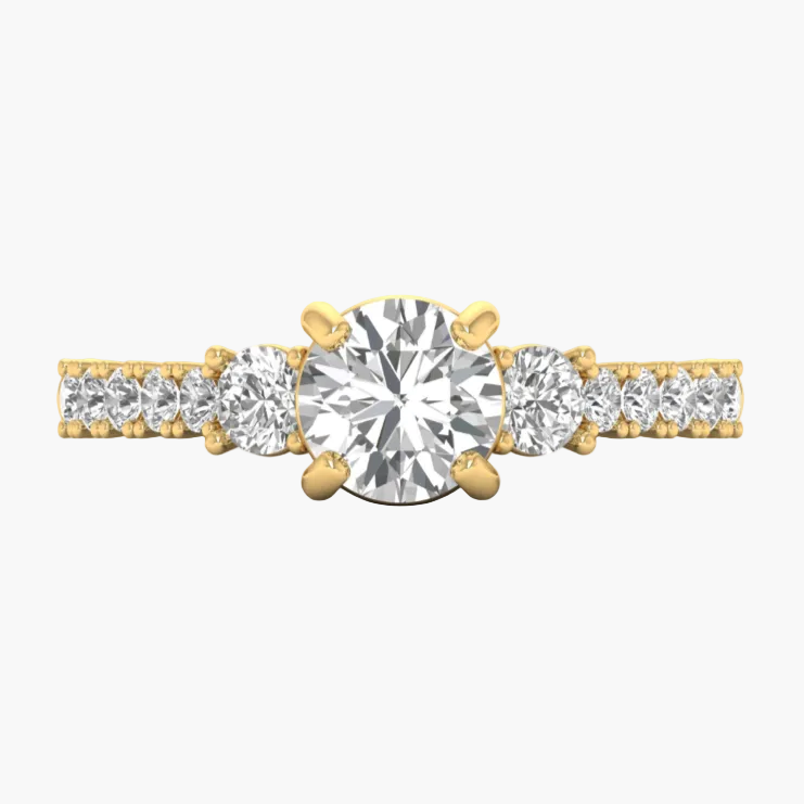 Gold ring with three prominent diamonds on a white background